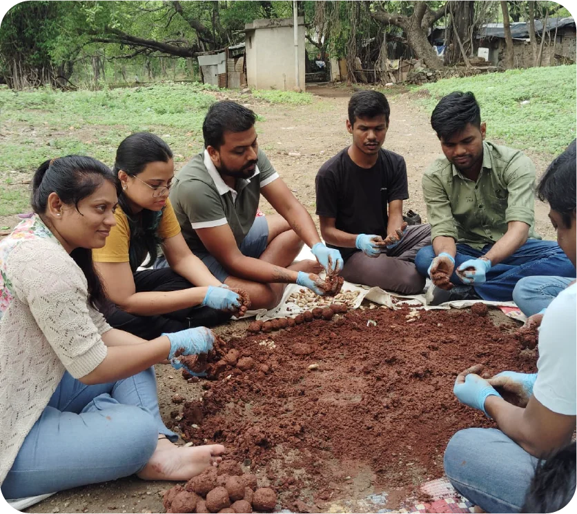 Instructor guiding a group during a seedball workshop session